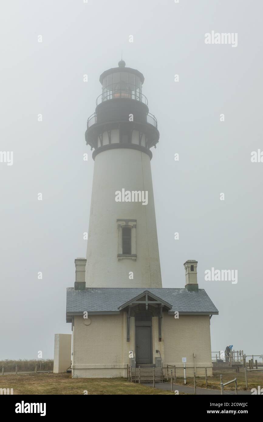 Vertical image - Closeup view of Yaquina Head Lighthouse in Oregon on a foggy day Stock Photo