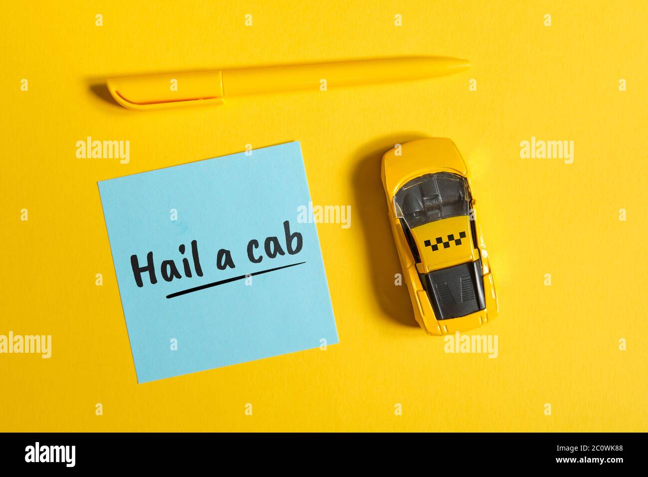 Taxi idiom in English hail a cab on sticker with car and sign on yellow background Stock Photo