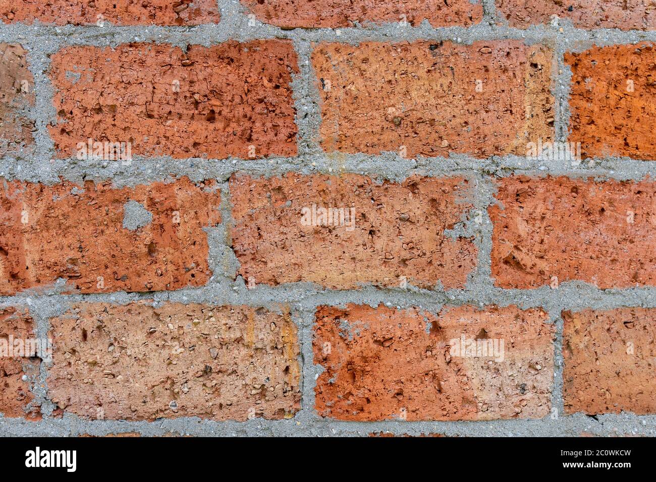 Weathered stained old brick wall background. Stock Photo