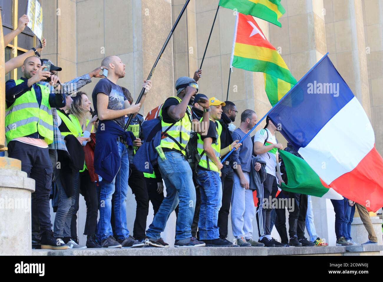 Angry yellow vest protesters screaming and waving flags at Trocadero in Paris France Stock Photo