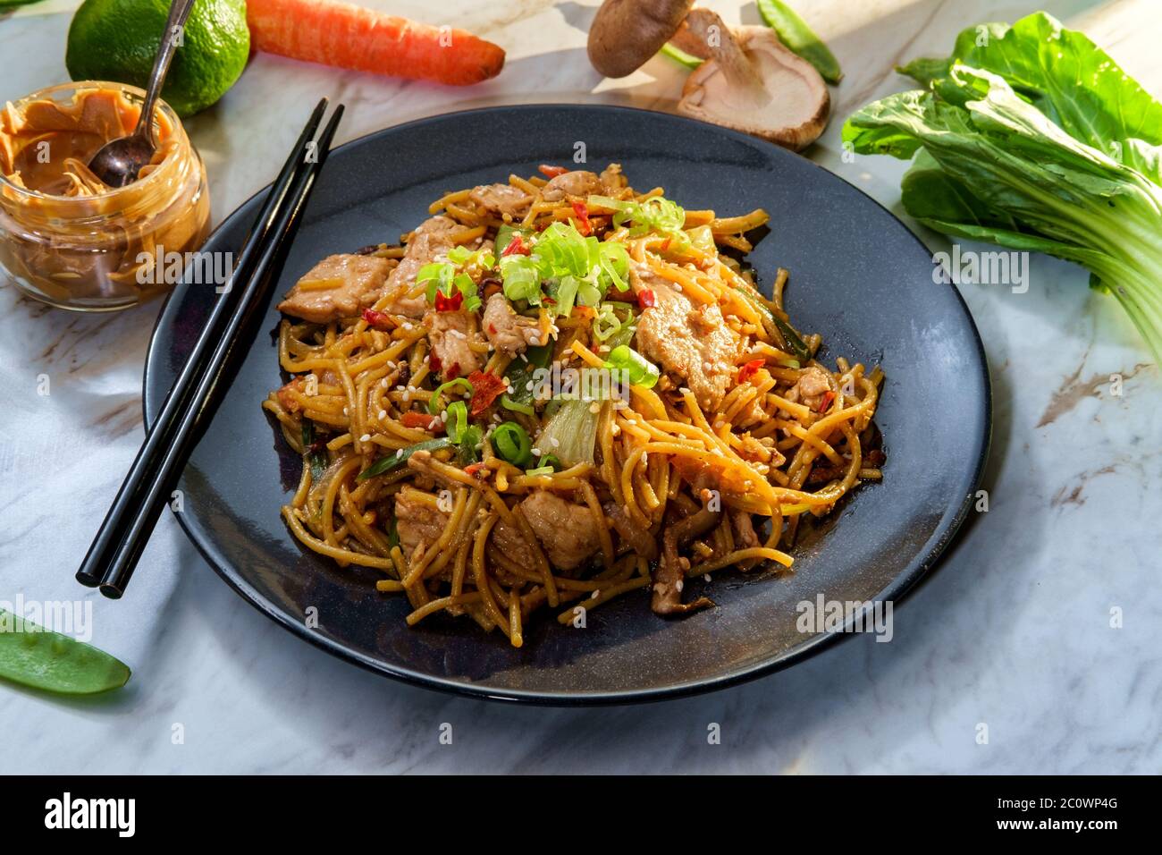 Spicy Thai chicken peanut butter lo mein noodles with sesame seeds