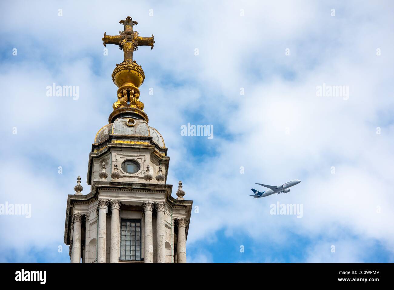 St Paul's Cathedral, London, England. Cross above the dome and aeroplane in sky. Stock Photo