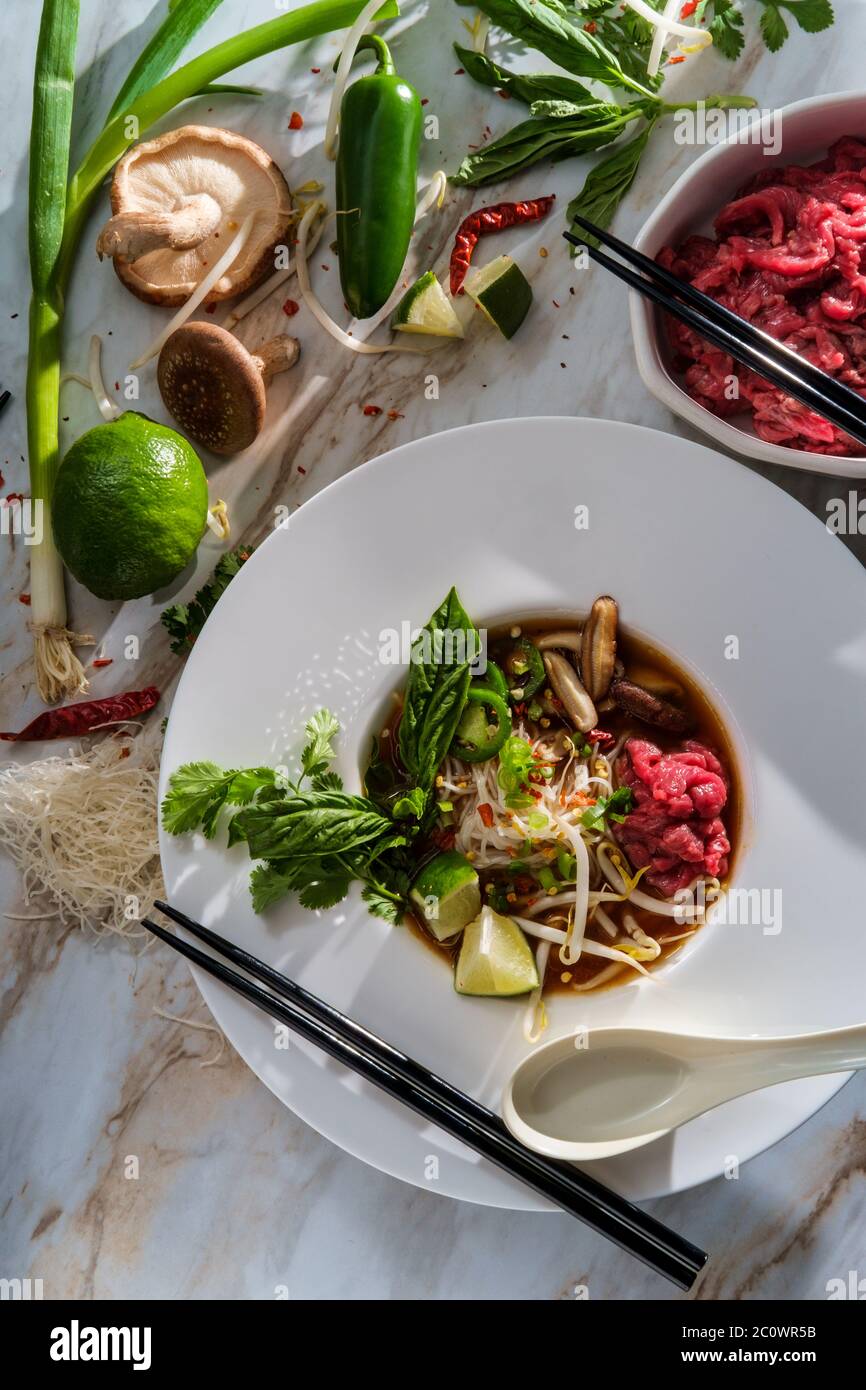 Traditional Vietnamese pho bo beef noodle soup served with noodles