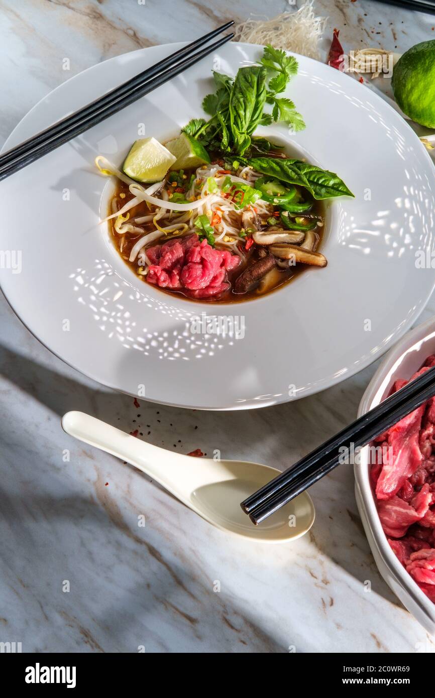 Traditional Vietnamese pho bo beef noodle soup served with noodles