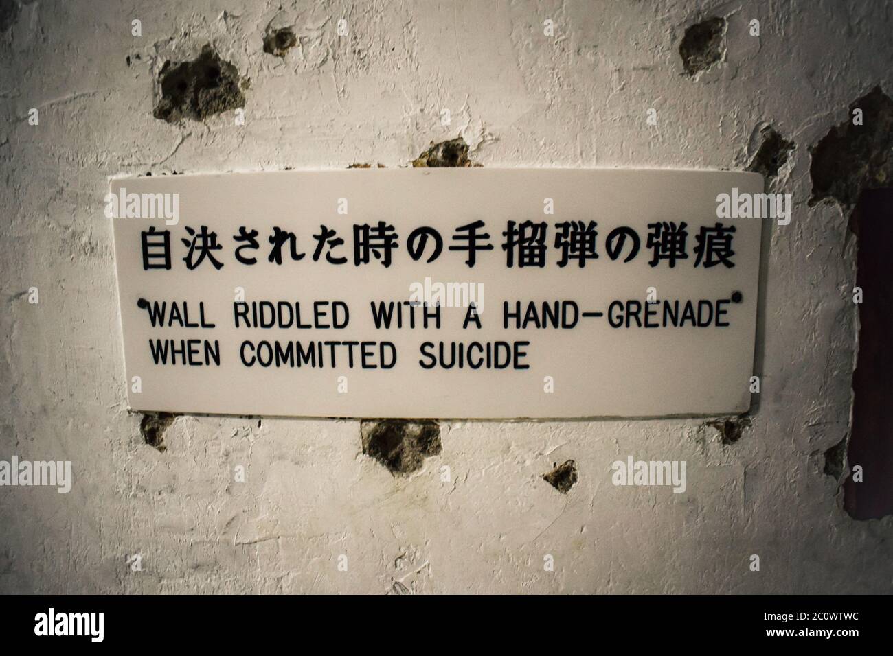 Wall riddled with a hand grenade in Former Japanese Navy Underground Headquarters in Naha Okinawa Stock Photo