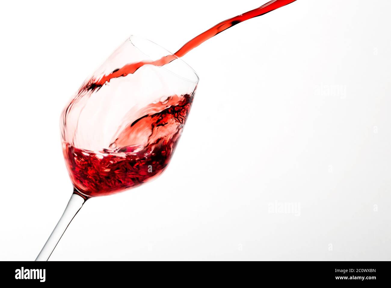 Splash of wineglass on white background Stock Photo