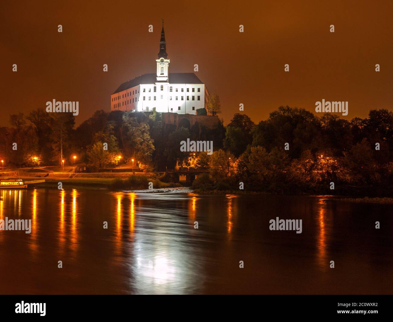 Decin Castle reflected in Elbe River by night, Czech Republic, Europe. Stock Photo