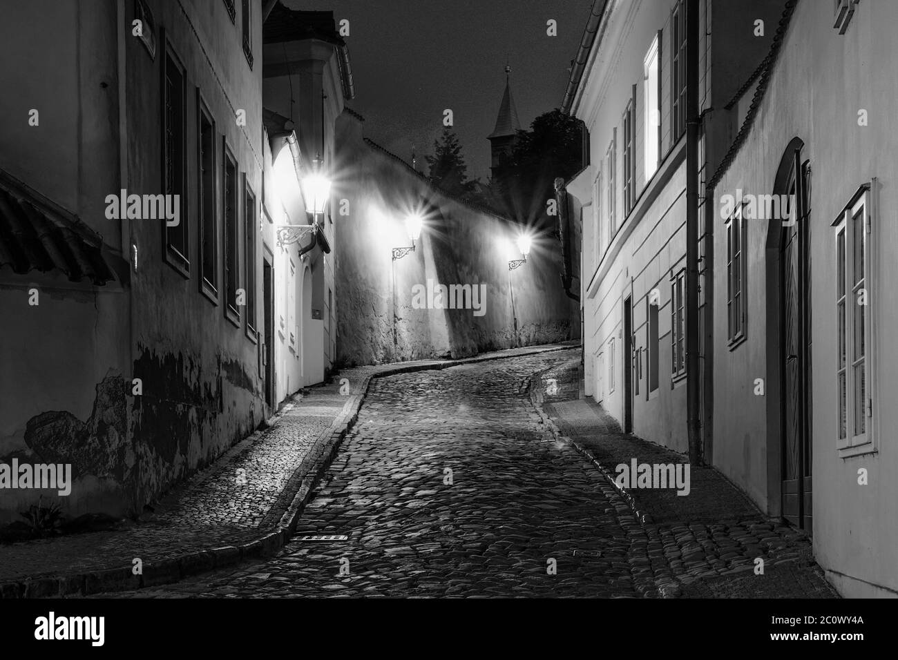 Hidden fairytale street in Prague Czech Republic Novy Svet quarter enlightened by street lamps during night Stock Photo