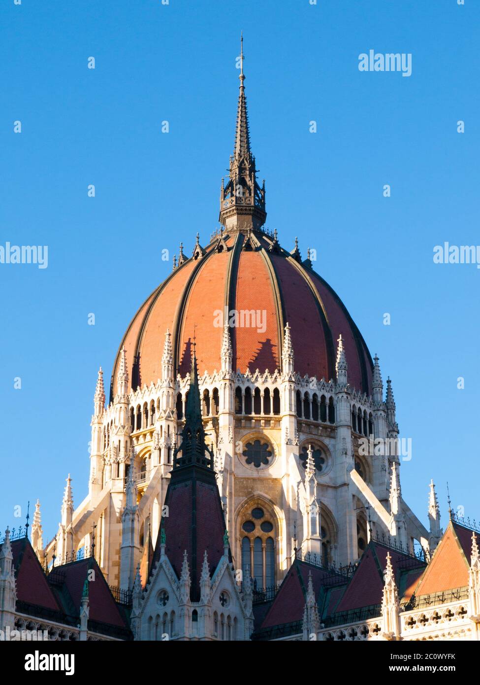 Detailed view of historical building of Hungarian Parliament, aka Orszaghaz, with typical central dome on clear blue sky background. Budapest, Hungary, Europe. It is notable landmark and seat of the National Assembly of Hungary. UNESCO World Heritage Site. Stock Photo