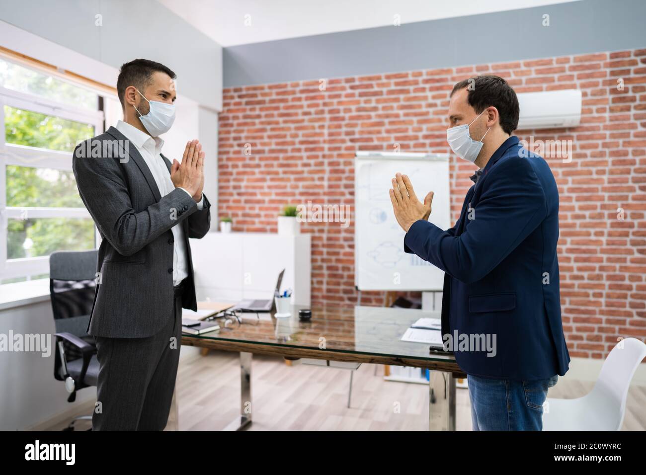 Man Avoiding Handshake To Stop Covid-19 Spread Doing Namaste Gesture Stock Photo