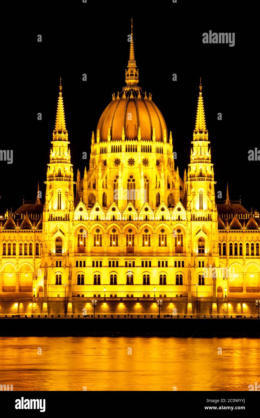 Central part of illuminated historical building of Hungarian Parliament on Danube River Embankment in Budapest by night, Hungary, Europe. Stock Photo