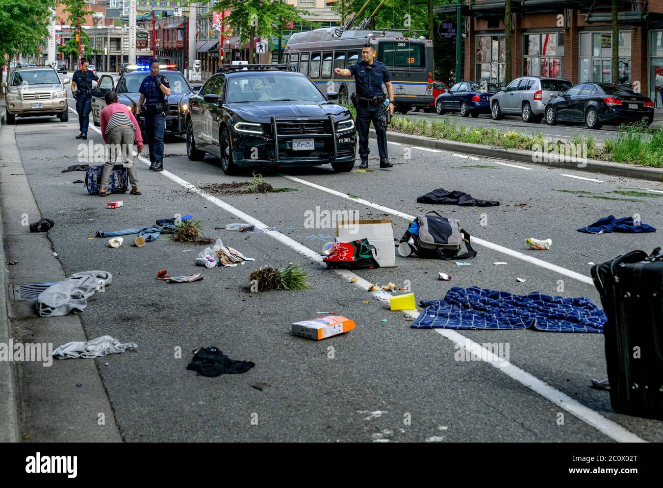 Vancouver Police respond to mentally ill woman with knife who dumped garbage all over street, Vancouver, British Columbia, Canada Stock Photo