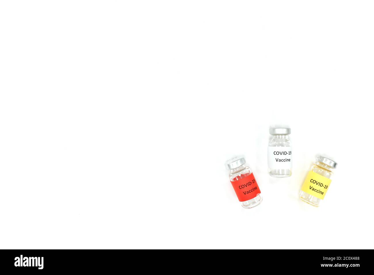 Covid-19 vaccine vials isolated in white background with copy space. Minimalist top view. Stock Photo