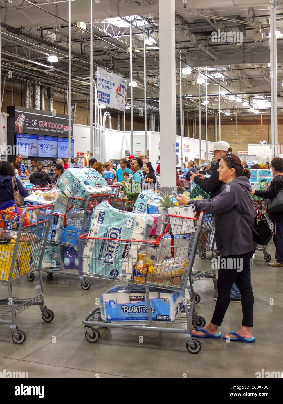 Shoppers frightened by the coronavirus in March 2020 stock up on paper ...