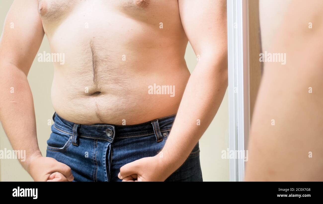 Fat young man with big belly pretending to be muscular and fit. Concept of  male overweight, weight loss and dieting Stock Photo - Alamy