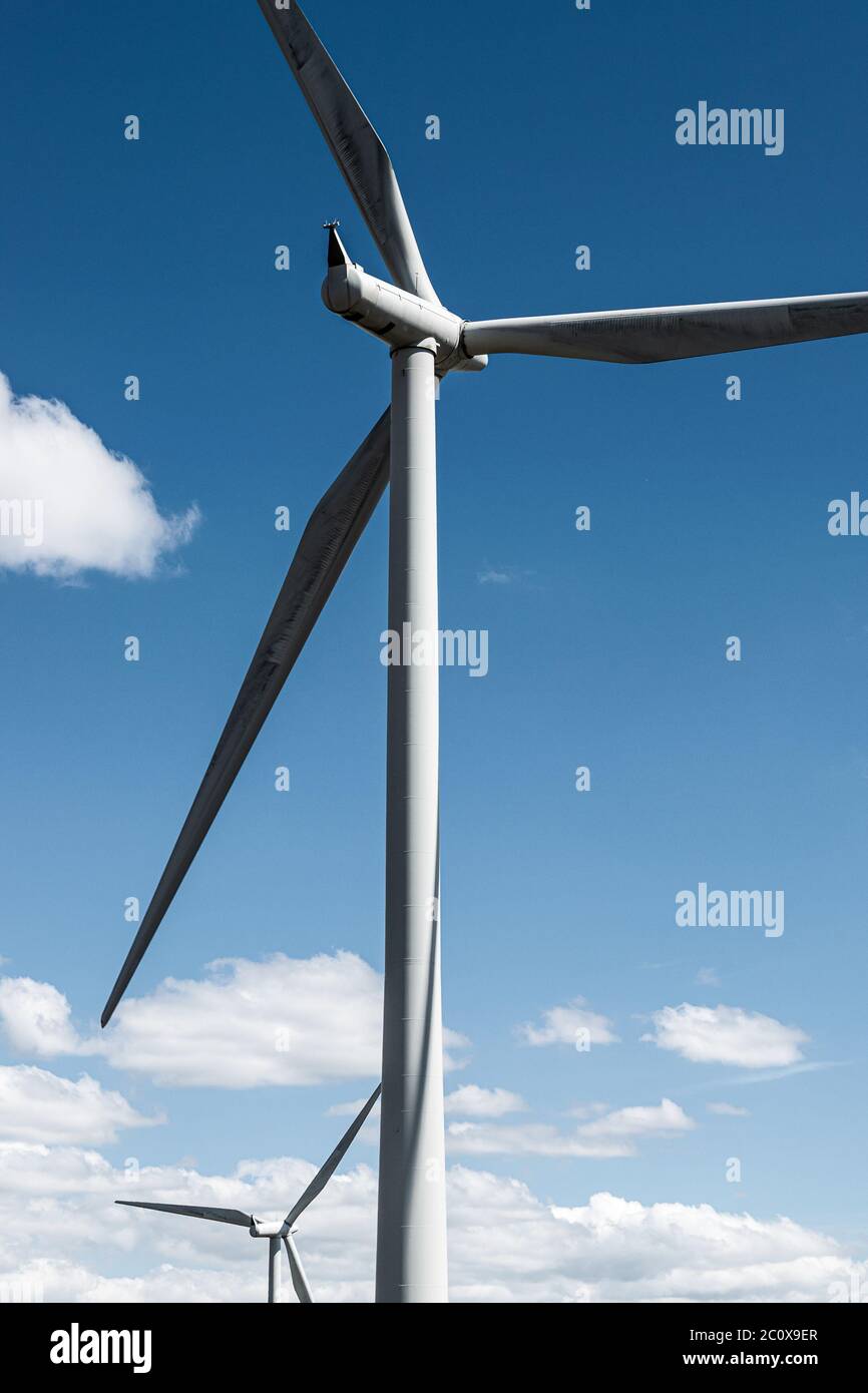 Two wind turbines on Whitelee windfarm, Scotland, against deep blue sky. Stock Photo