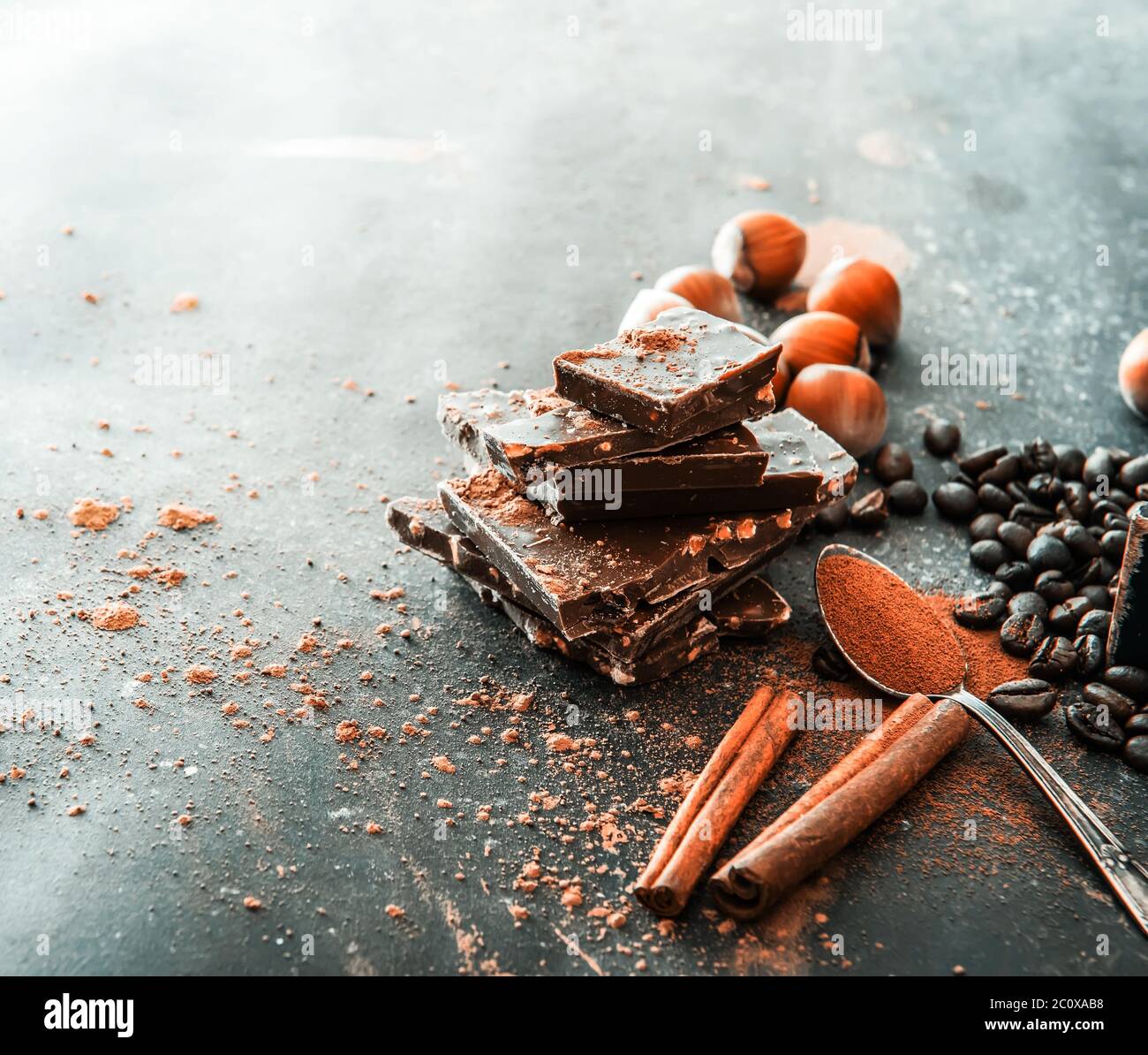 Chocolate, nuts, spices on a smooth black table Stock Photo