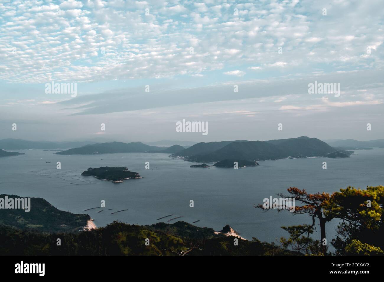 Beautiful view on trees and cloudy sky and pearl farms from Mount Misen at Miyajima island in Hiroshima Japan Stock Photo