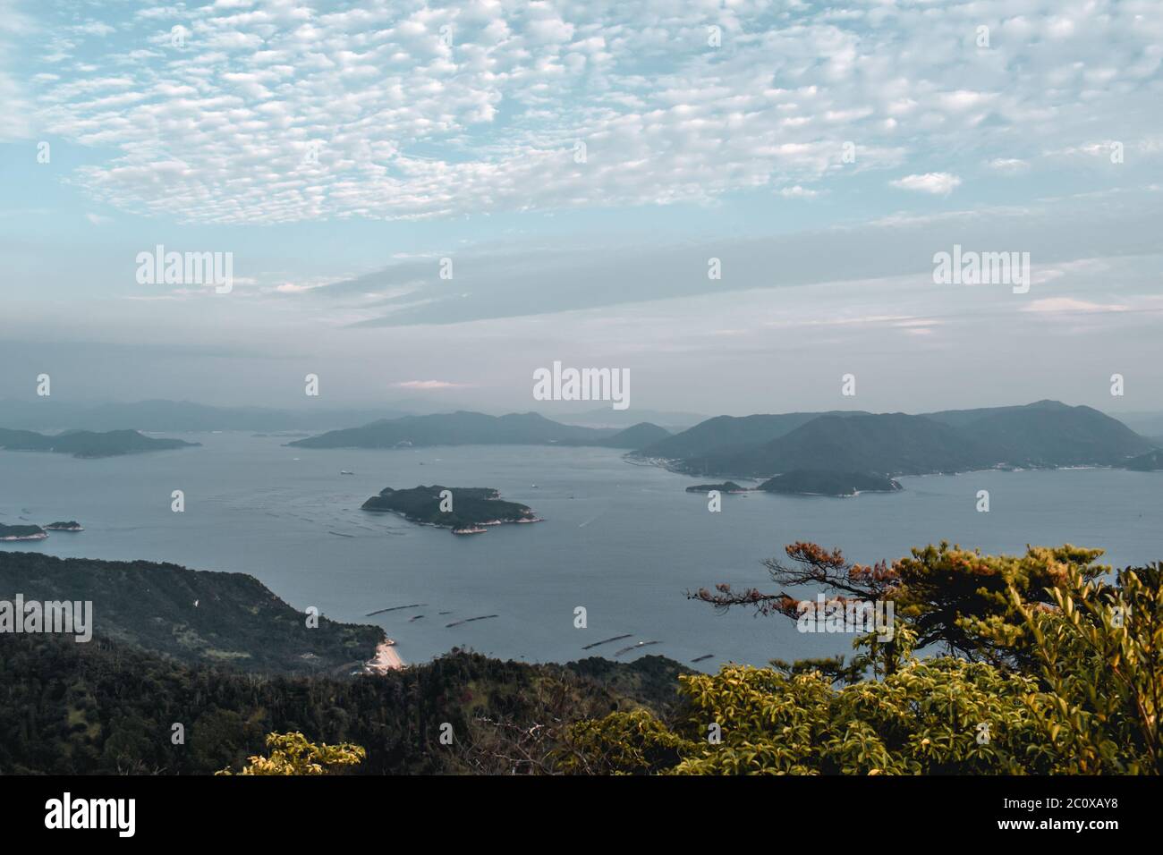 Beautiful view on trees, islands and cloudy sky and pearl farms from Mount Misen at Miyajima island in Hiroshima Japan Stock Photo