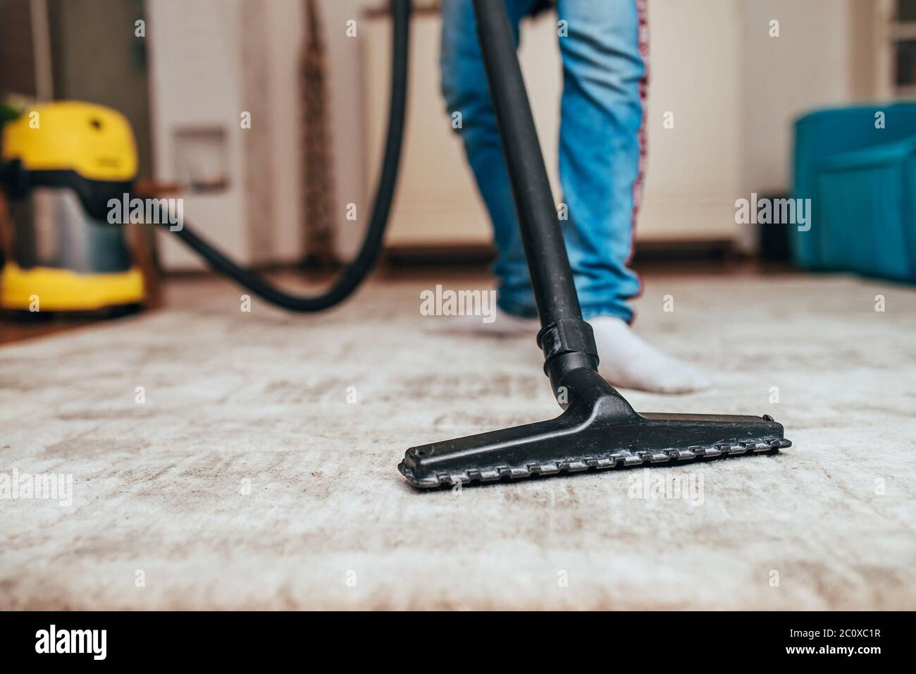 Dry cleaning of carpeting - washing vacuum cleaner on the carpet during cleaning Stock Photo