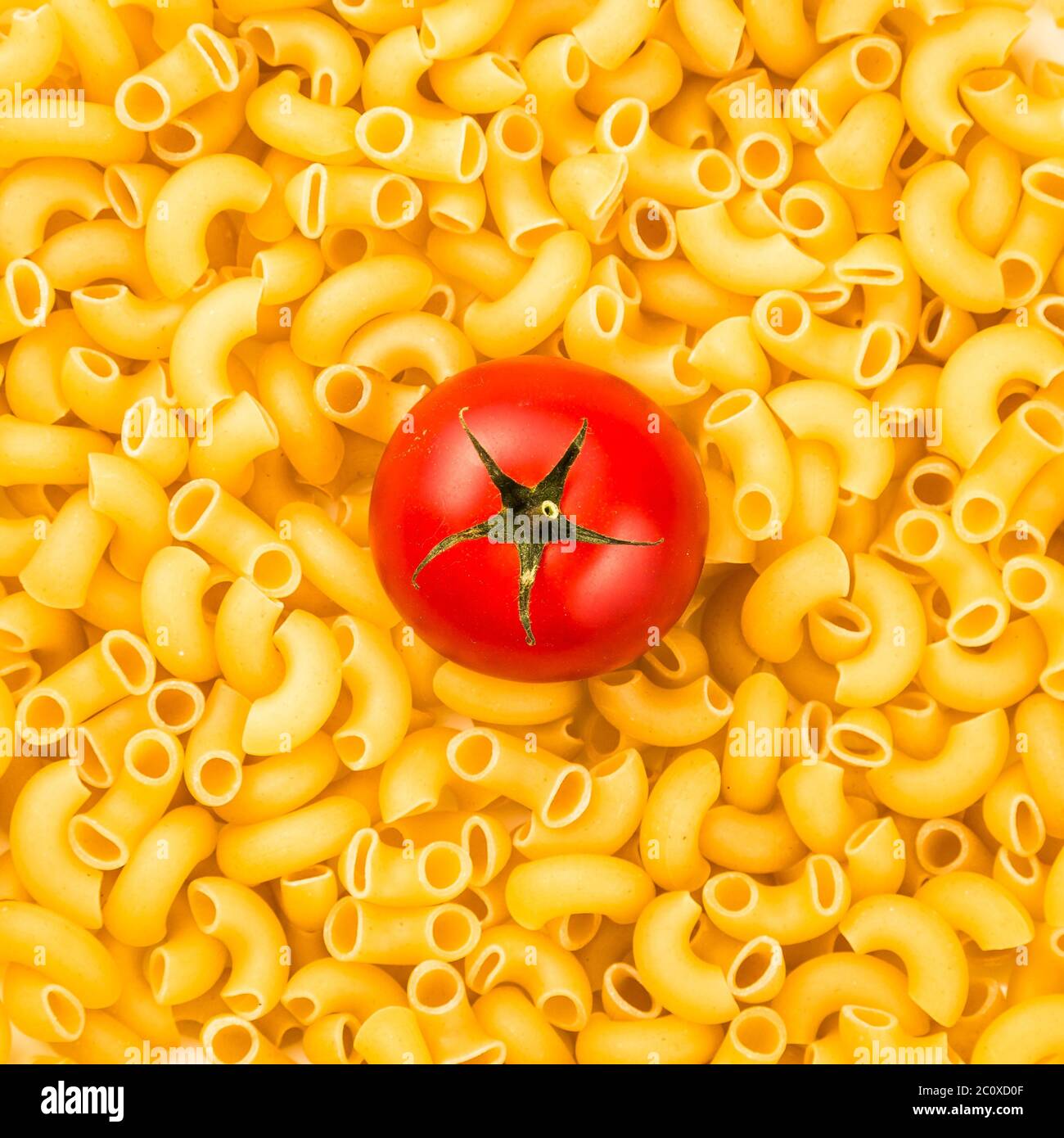 Pasta texture background with tomato Stock Photo