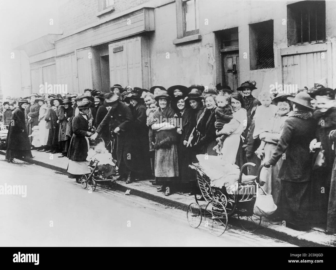 Women and Children waiting in Bread Line, England, National Photo Company Collection, 1914 Stock Photo