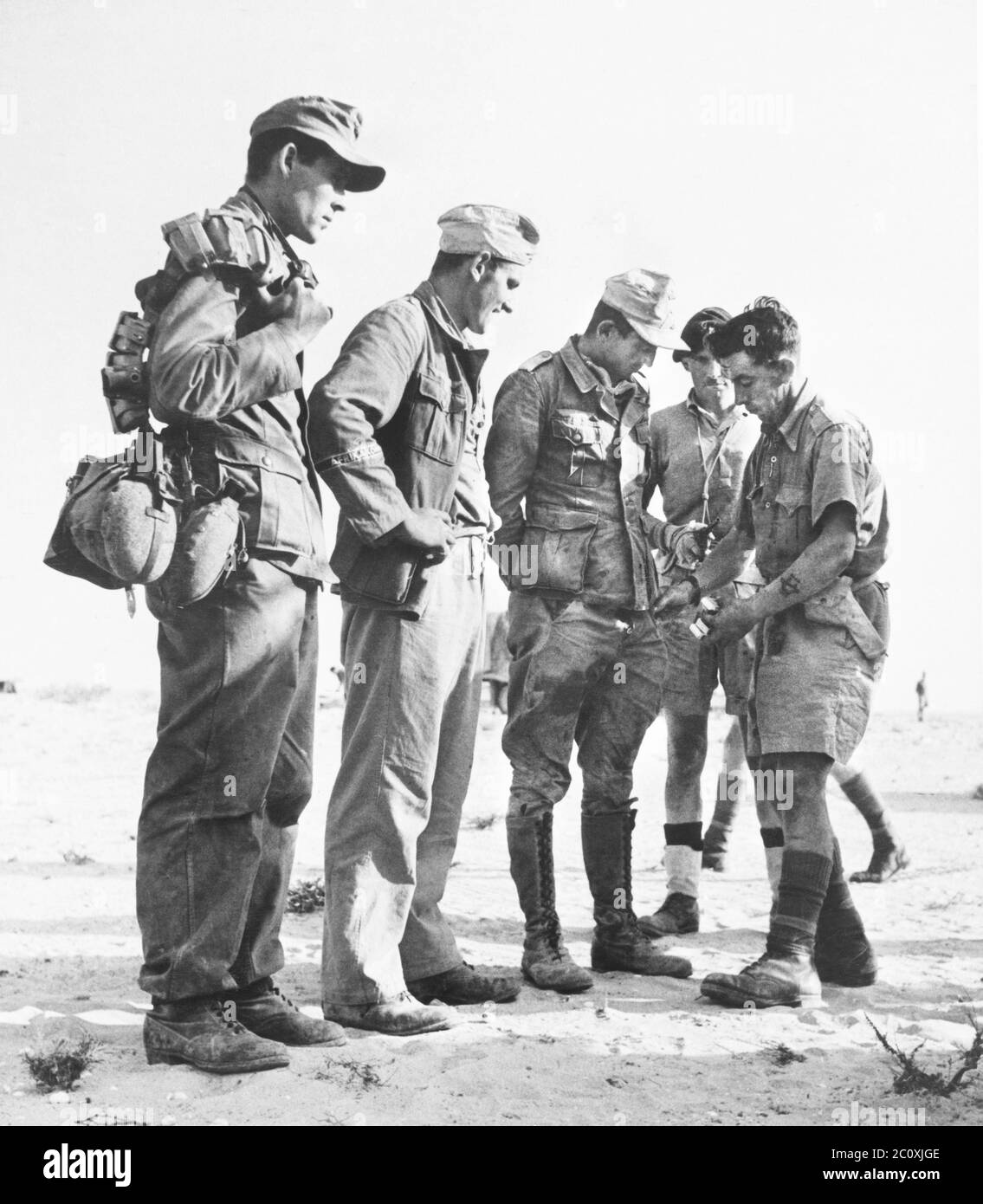 German prisoners, members of German Crack Division, the 90th Light Div., being searched after being captured south of El Alamein, Egypt, British official photograph, 1942 Stock Photo