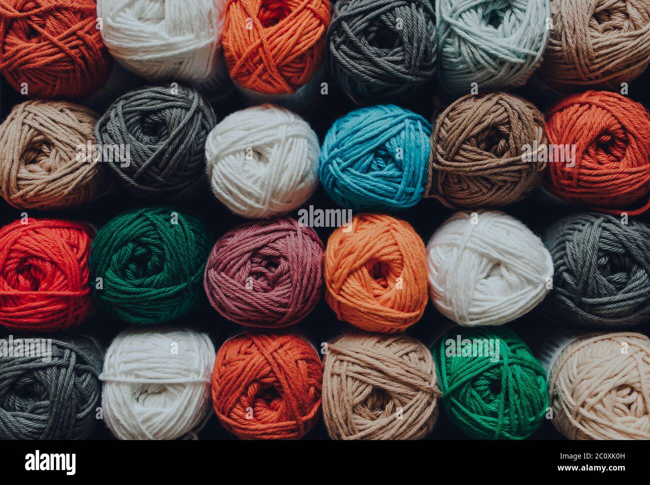 Overhead shot of rows of skeins of amigurumi cotton yarn in different