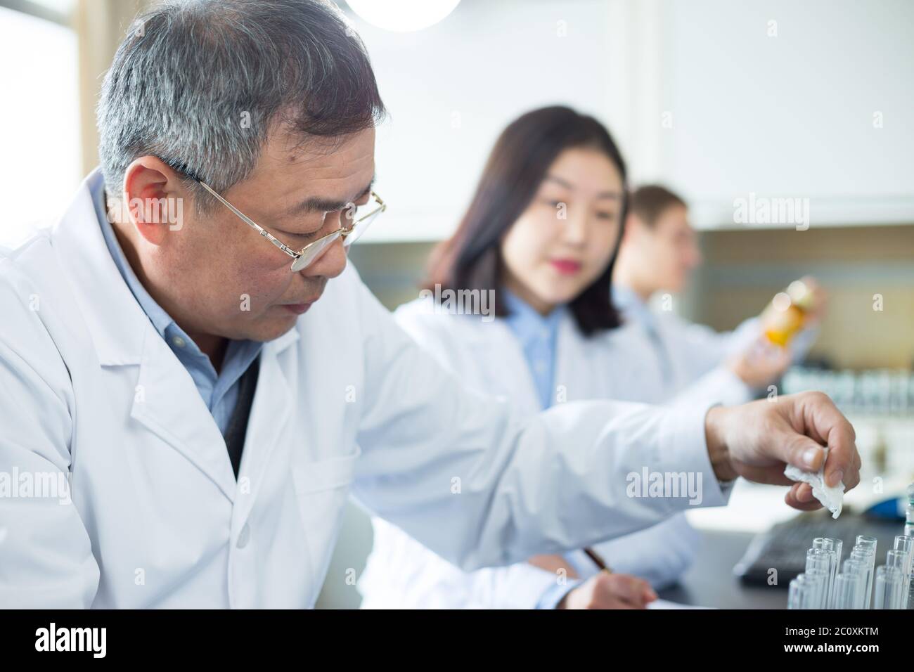 people doing chemical experiment in modern lab Stock Photo