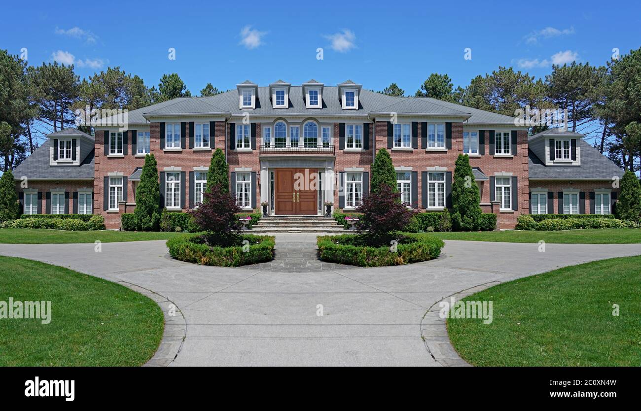 Large suburban house with landscaping and circular driveway Stock Photo