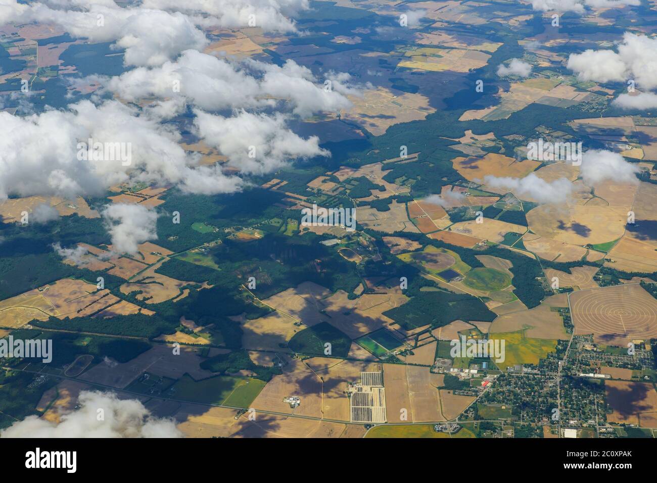 Airplane view panorama above blue sky with to land of fields with planted crops Stock Photo