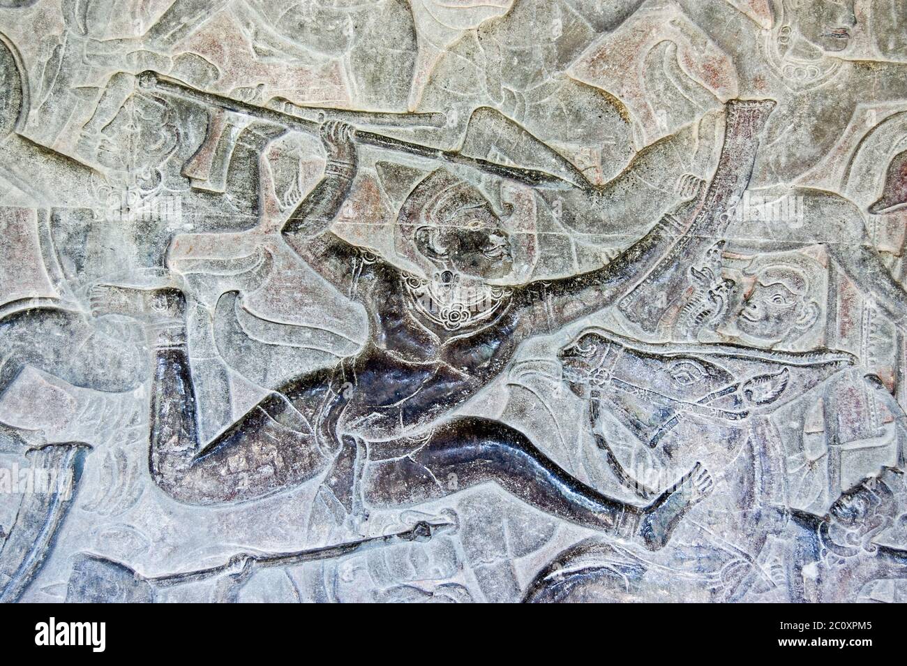 Ancient bas relief sculpture of a soldier throwing a spear during battle. Interior wall of Angkor Wat temple, Siem Reap, Cambodia. Stock Photo