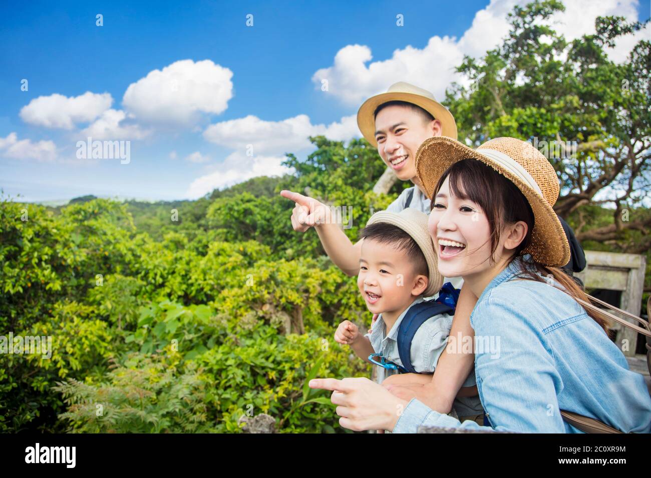 happy family hiking through the forest and looking the view Stock Photo ...