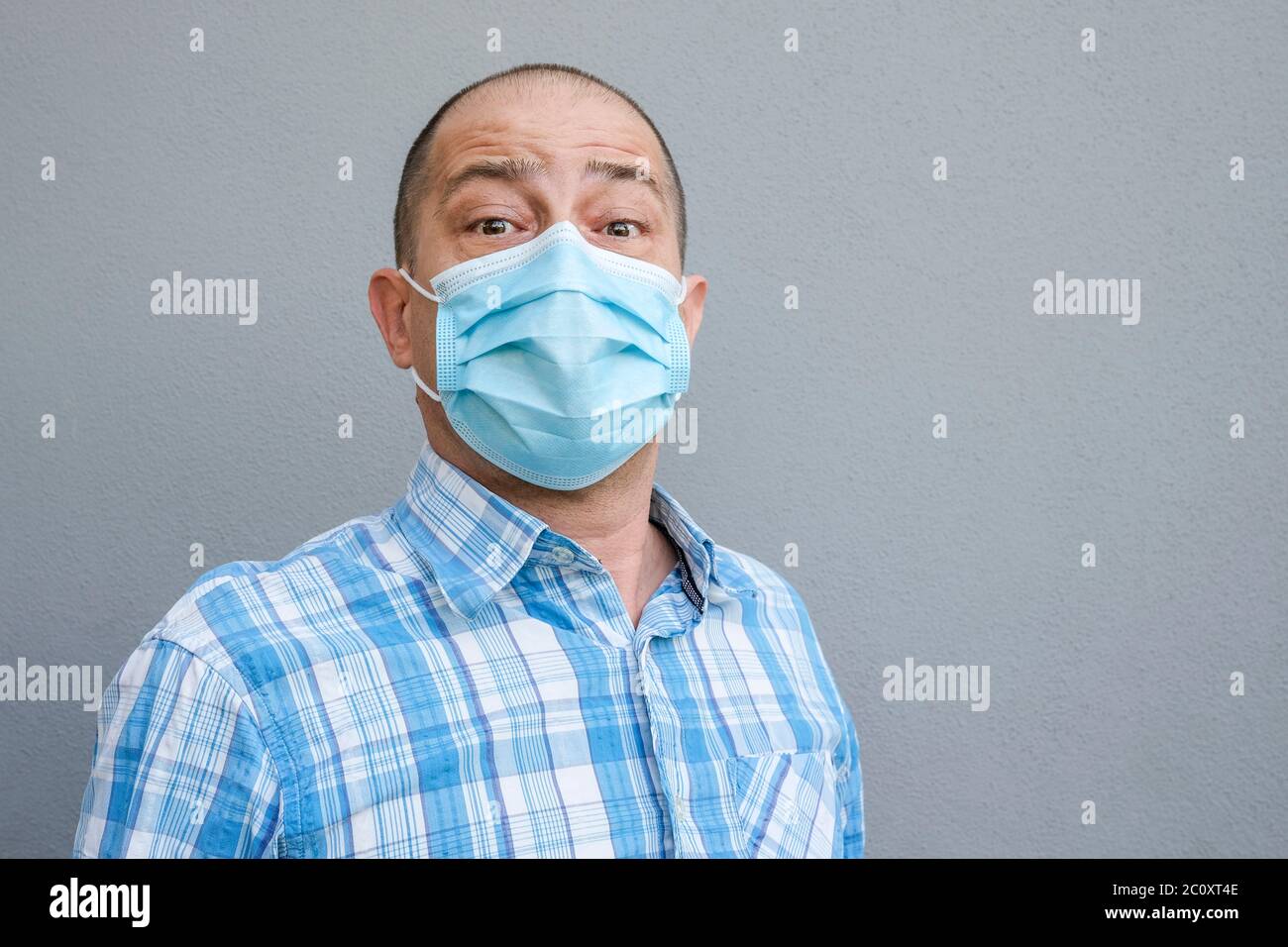 Man wearing a surgical face mask in prevention of pandemic disease ...