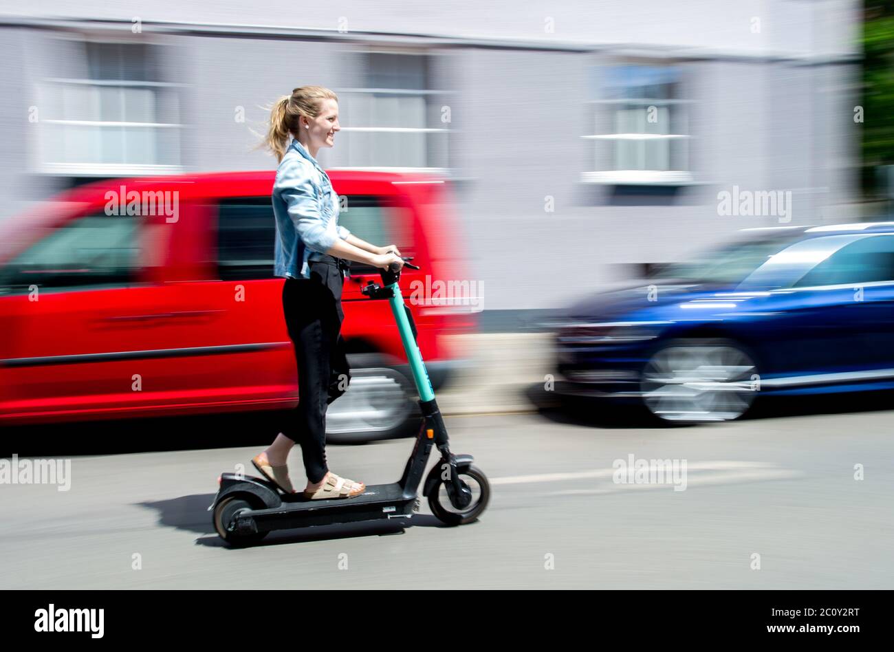 Hanover, Germany. 12th June, 2020. Lina rides an electric scooter from the  electric scooter sharing provider Tier Mobility (shot with a long shutter  speed). E-scooters have been available for use in Germany