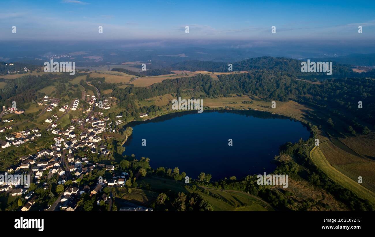 Schalkenmehren, Germany. 12th June, 2020. The Schalkenmehrener Maar. Aerial view with a drone. The Eifel volcanism is still active. Researchers have measured that the earth there rises and is also pressed outwards from below. However, experts do not see the danger of an early eruption. (To dpa 'New study proves: Under the Eifel is still bubbling') Credit: Thomas Frey/dpa/Alamy Live News Stock Photo