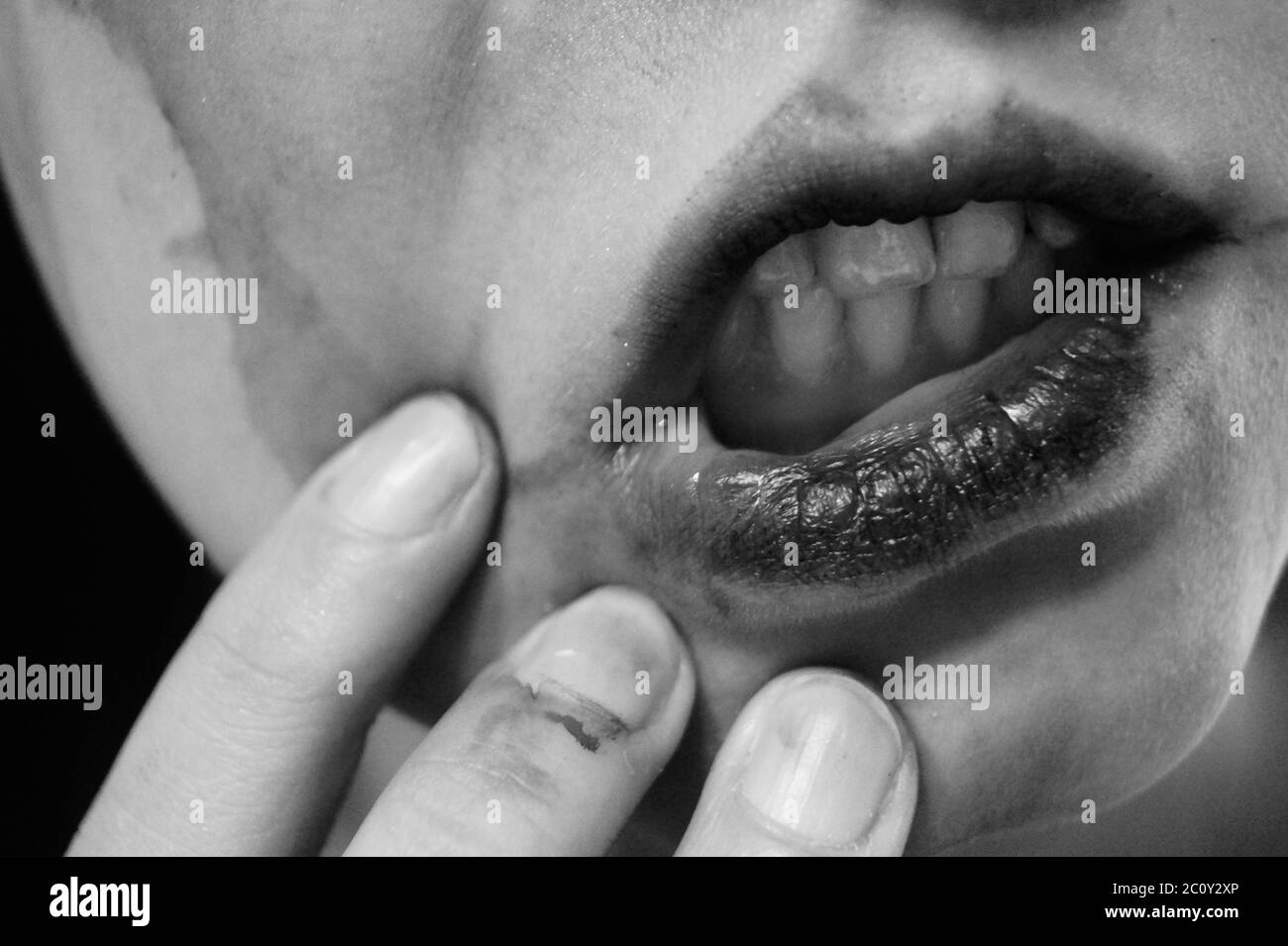 A close up of mouth, black and white soul sad makeup halloween psycho black tears ink Stock Photo