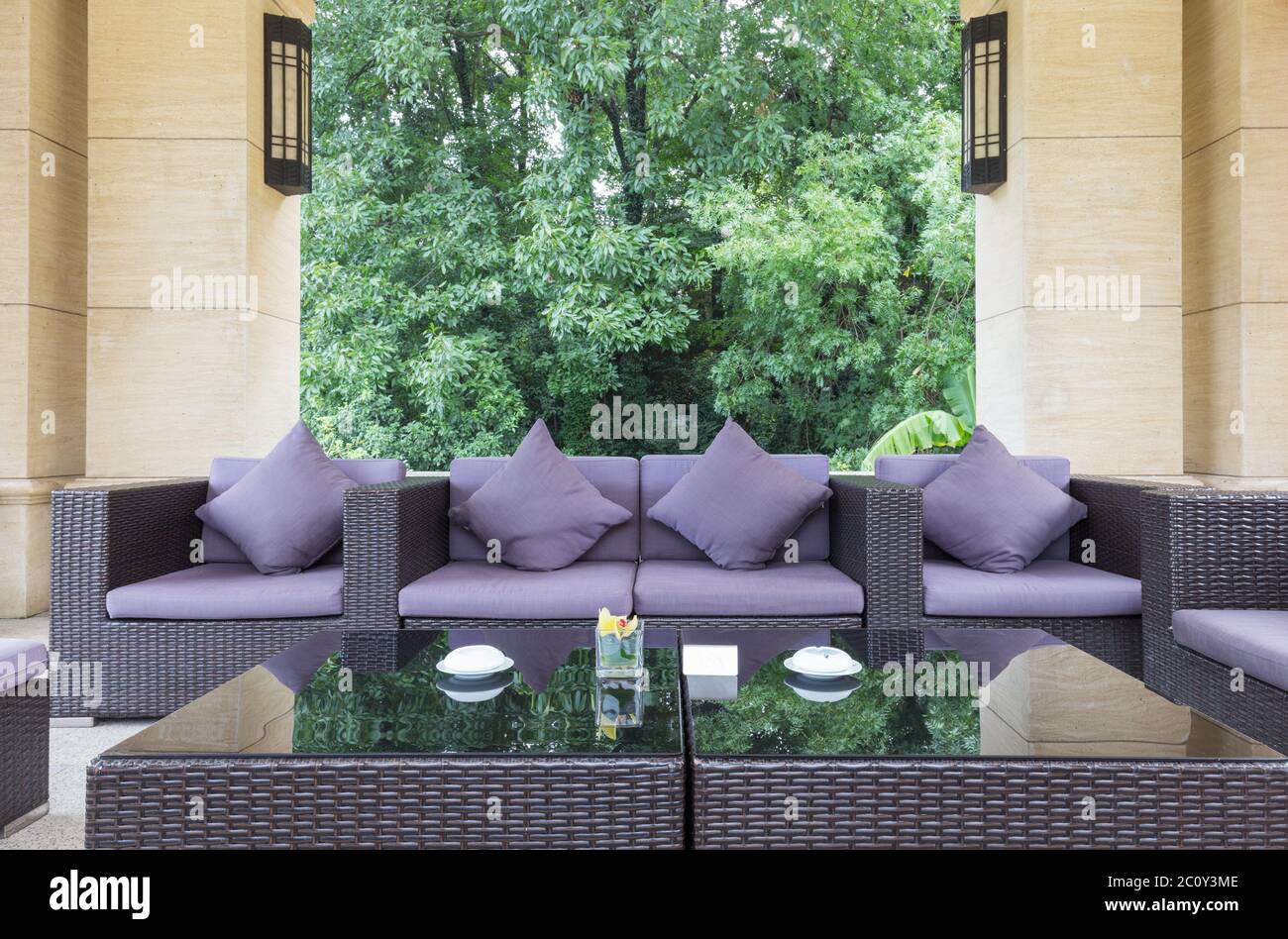 elegant purple sofas in modern building in back yard Stock Photo
