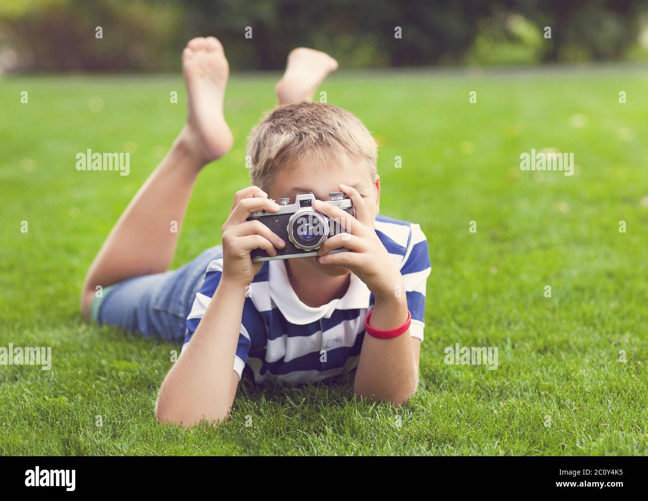 Happy smiling little boy with retro vintage camera Stock Photo