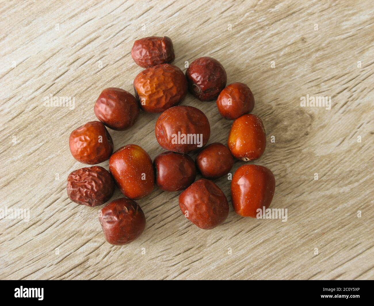Dried unabi fruit or jujube isolated on wooden background. Ziziphus