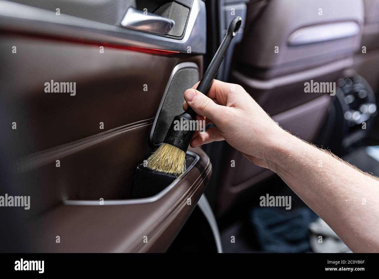 Man car detailing studio worker cleaning car interior Stock Photo