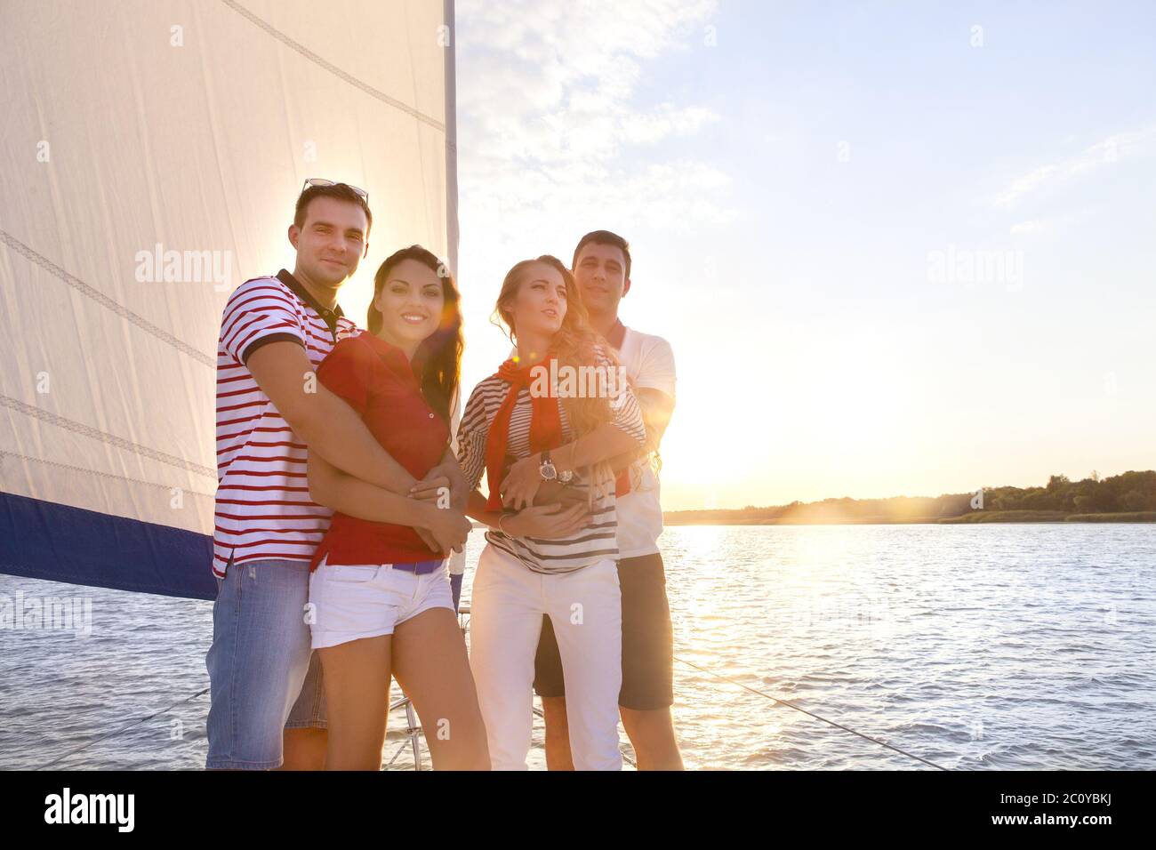 Smiling friends on yacht deck and greeting Stock Photo - Alamy