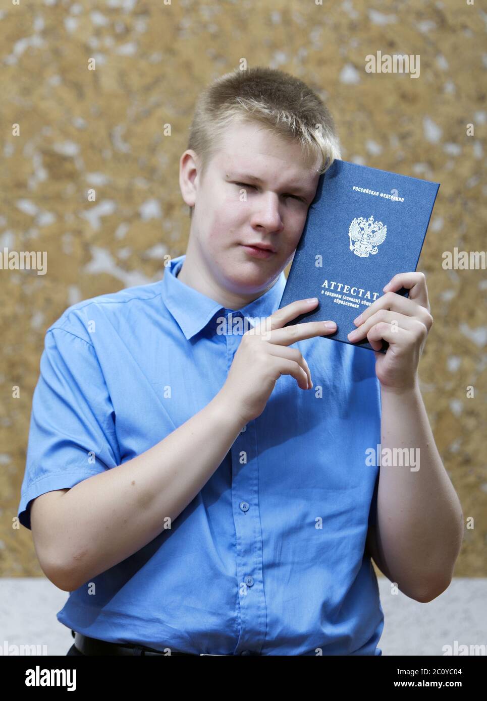 schoolboy with the certificate about completion of education at school , upset from parting with sch Stock Photo