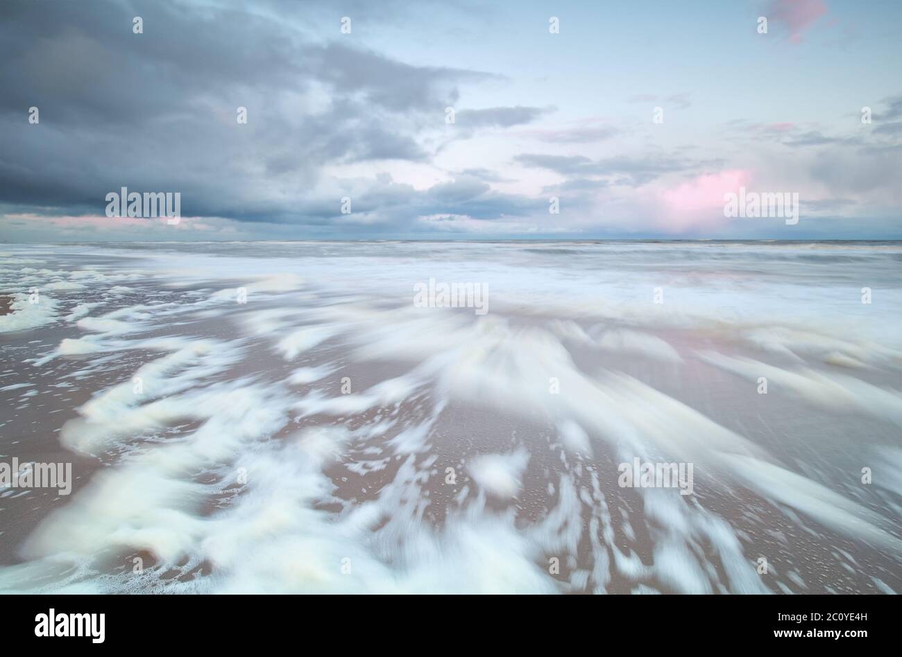 blurred sea waves at sunrise Stock Photo