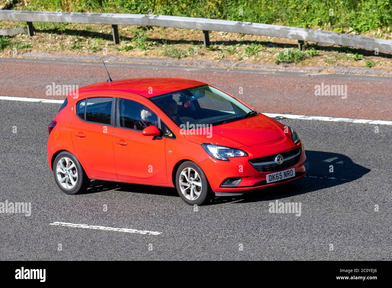 2015 red Vauxhall Corsa Excite AC; Vehicular traffic moving vehicles, cars driving vehicle on UK roads, motors, motoring on the M6 motorway Stock Photo