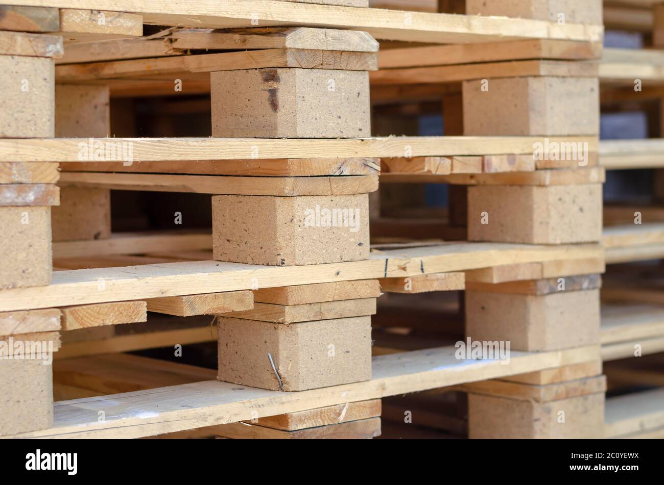A stack of new wooden pallets. Empty pallets in a warehouse yard