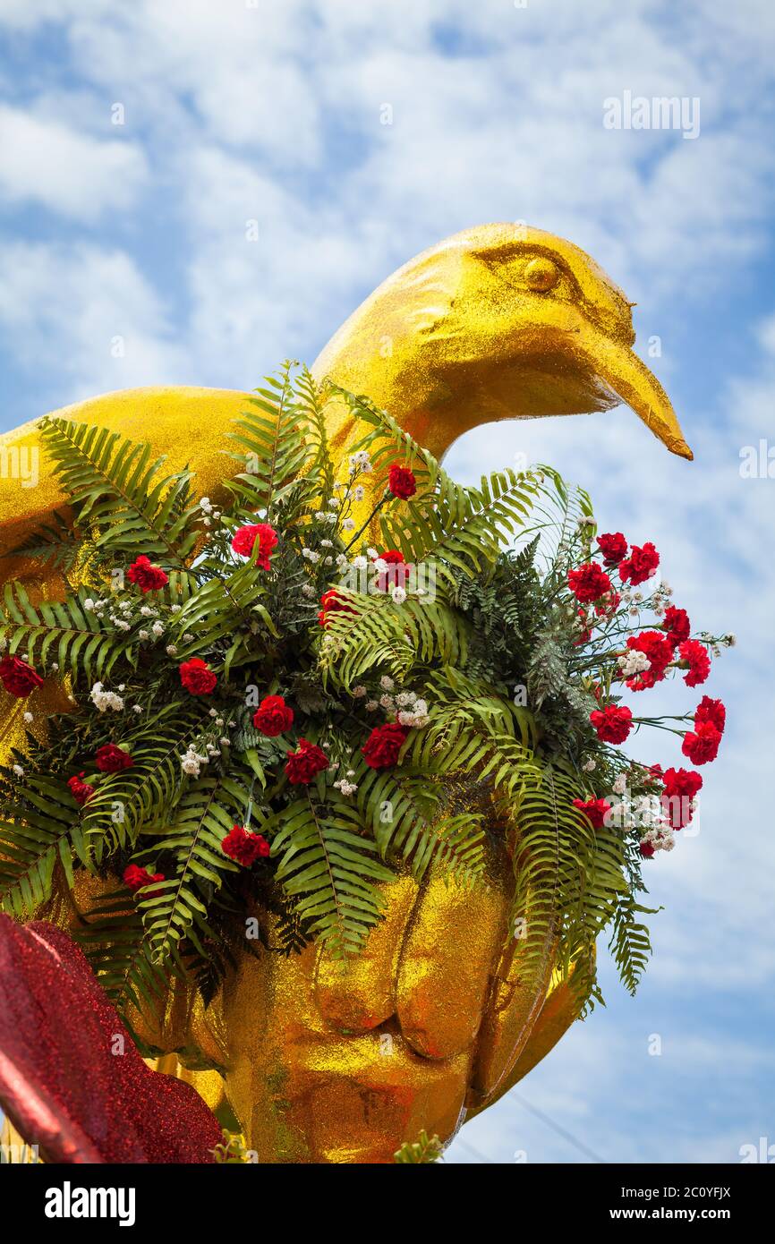 Flowers and a golden bird at the 'Mil de polleras' festival (thousand polleras) in Las Tablas, Los Santos province, Republic of Panama. Stock Photo