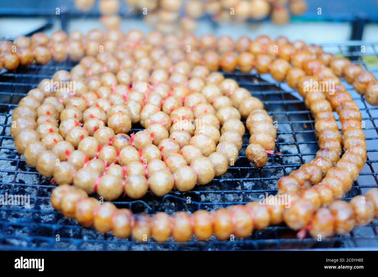 Grilling Round Thai Sausages Stock Photo