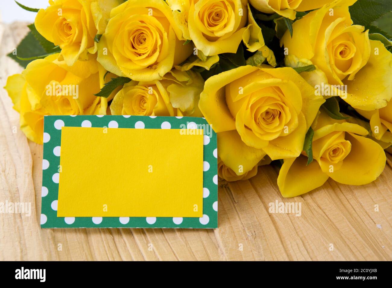 Yellow roses and card Stock Photo - Alamy