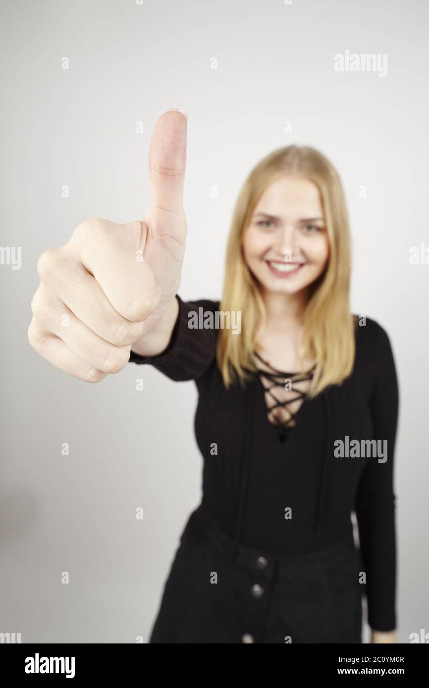 Thumbs up holding young hi-res stock photography and images - Alamy